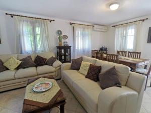 a living room with two couches and a table at Klea's House Skopelos in Skopelos Town
