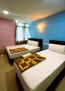 Postel nebo postele na pokoji v ubytování ARK HOTEL SUBANG
