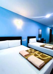 Postel nebo postele na pokoji v ubytování ARK HOTEL SUBANG