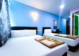 Postel nebo postele na pokoji v ubytování ARK HOTEL SUBANG