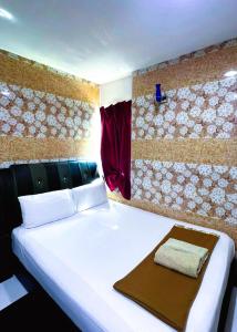 Postel nebo postele na pokoji v ubytování ARK HOTEL SUBANG