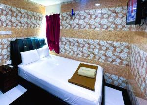 Postel nebo postele na pokoji v ubytování ARK HOTEL SUBANG