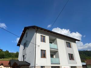 a white building with a blue sky in the background at U Fera in Stará Bystrica