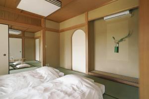 Uma cama ou camas num quarto em 赤城宿 珠蕾山荘-shurai-