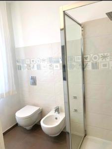 a bathroom with a toilet and a sink at Casa Giulù- in Palermo +17 photos