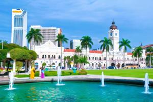 a city with a fountain in front of a building at ARK HOTEL MELAWATI in Kuala Lumpur