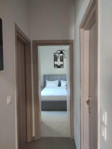 a bedroom with a bed and a door leading into a room at Crystal Private Pool House in Artemida