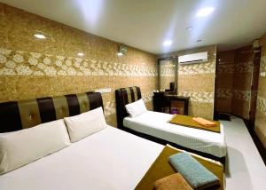 a hotel room with two beds and a fireplace at ARK HOTEL MELAWATI in Kuala Lumpur +62 photos