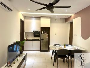 a kitchen and dining room with a table and a ceiling fan at KAVENUE Cybercity Sunset View, 8-10 pax in Donggongon