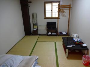 Postel nebo postele na pokoji v ubytování Imazato Ryokan