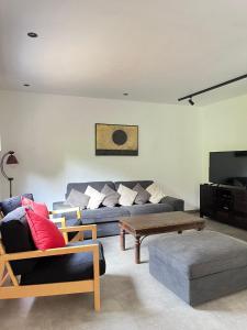 a living room with a couch and a coffee table at le nidouette in Gedinne