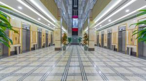 an empty hallway in a building with potted plants at VERTA Almahbas Hotel in Makkah