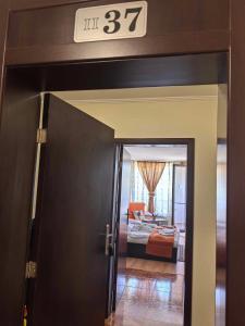 a door leading to a room with a bed and a clock at Elza Apartment in Pamporovo +5 photos