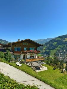a house on top of a grassy hill with avisor at Haus Kropfa in Hippach
