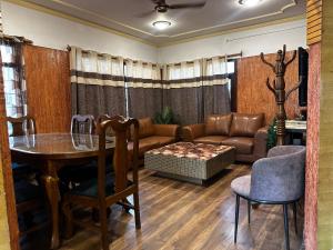 a living room with a table and a couch at Srinagar Luxury Escape - Dilan Residency in Srinagar