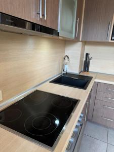 a kitchen with a sink and a stove at Dārzu ielas apartamenti in Rēzekne