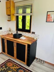 a kitchen with a wooden counter and a window at The Burds Nest in West Hatch