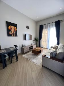 a living room with a couch and a table at Skyline residence Kyanja in Kampala