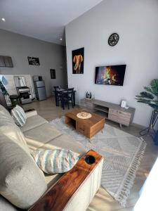 a living room with a couch and a table at Skyline residence Kyanja in Kampala