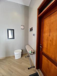 a room with a chair next to a door at Skyline residence Kyanja in Kampala