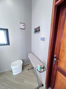 an empty room with a chair and a door at Skyline residence Kyanja in Kampala