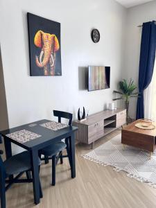 a living room with a table and a dining room at Skyline residence Kyanja in Kampala