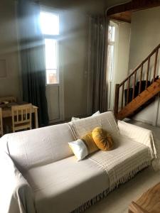 a white bed with two pillows on it in a room at Central Loft 7 in Kalamata