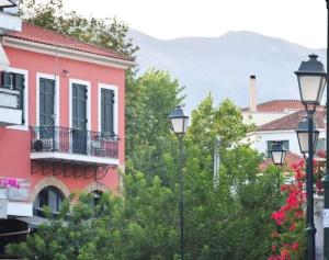 a group of buildings with trees and street lights at Central Loft 7 in Kalamata