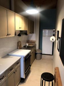 a small kitchen with a stove and a refrigerator at Central Loft 7 in Kalamata