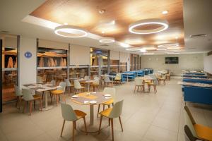 a dining room with tables and chairs in a cafeteria at Zephyr Agadir in Agadir