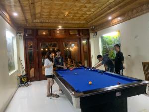 a group of people standing around a pool table at Thanh Truc House in Sa Pa +8 photos