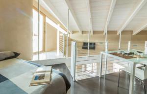 a room with a bed and a desk and a table at B&B éve in Aosta