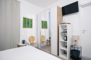 a bedroom with a bed and a mirror at Flora Inn, Scotti's House - Due passi in centro in Bergamo