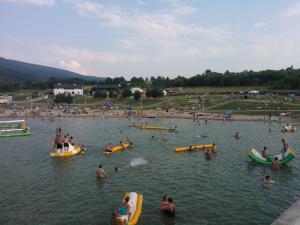 a group of people in the water at a beach at Folwark in Stronie Śląskie