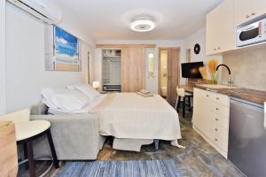 a kitchen with a table and a couch in a room at AMELIA apartment in Nea Moudania