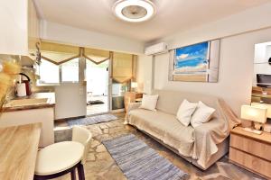 a living room with a couch and a kitchen at AMELIA apartment in Nea Moudania