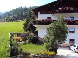 a building with flowers on the balconies of it at Haus Fliri in Curon Venosta