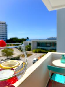 a glass bowl of fruit on a table on a balcony at Barinel Ocean Breeze in Alvor