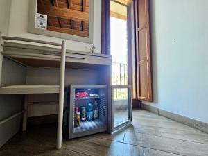 an open refrigerator with drinks in it in a room at B&B Leofreni Natura in Leofreni