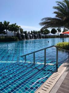 a large swimming pool with a rail in the water at Majestic maxim 3BR luxury family house MRT kuala lumpur in Kuala Lumpur