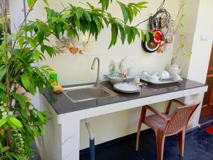 a kitchen counter with a sink and a chair at Happy Stay Mirissa in Mirissa