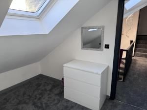 a room with a white dresser and a mirror at City Apartment Sleeps 5 with Parking in Manchester