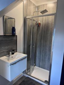a bathroom with a shower and a sink at City Apartment Sleeps 5 with Parking in Manchester