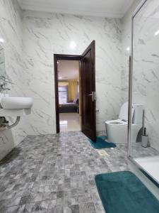 a bathroom with a tub and a toilet and a sink at 2 bedroom Jab Villa in Adentan