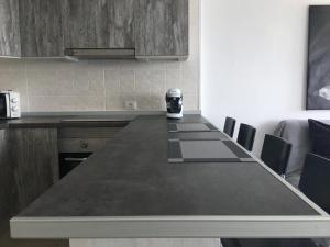 a kitchen with a long table with a coffee maker on it at Mirador La Galera, junto a la playa in Candelaria