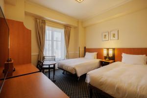 Postel nebo postele na pokoji v ubytování Hotel Monterey Sendai