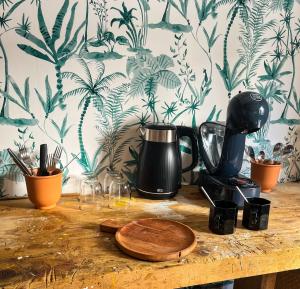 a counter top with a coffee maker and a coffee pot at Studio de charme proche de la gare, et du centre ville in Rennes +2 photos