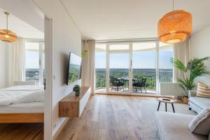 a bedroom with a bed and a living room at Best Butler Skyline Lodge City Apartment Netflix in Augsburg