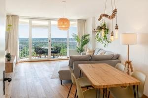 a living room with a couch and a table at Best Butler Skyline Lodge City Apartment Netflix in Augsburg