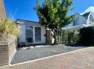 a house with a garage with a fence at Royal Green in Zandvoort